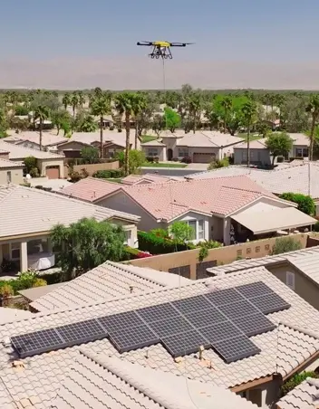 Cleaning drone flying over a utility-scale solar farm