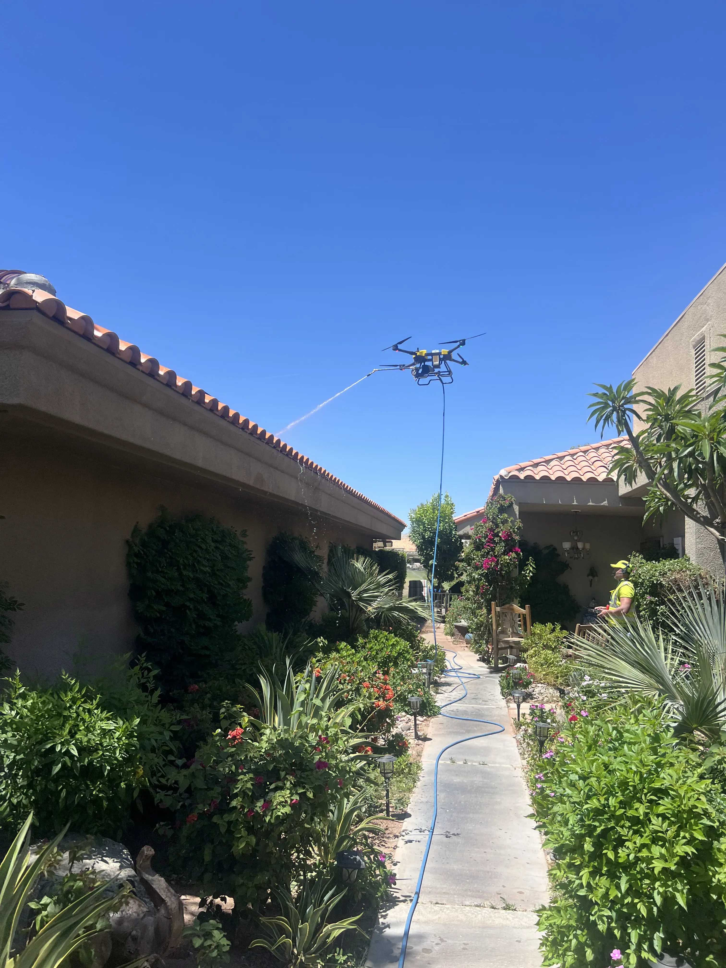 DronePower1 operator working in a narrow courtyard between multi-story buildings