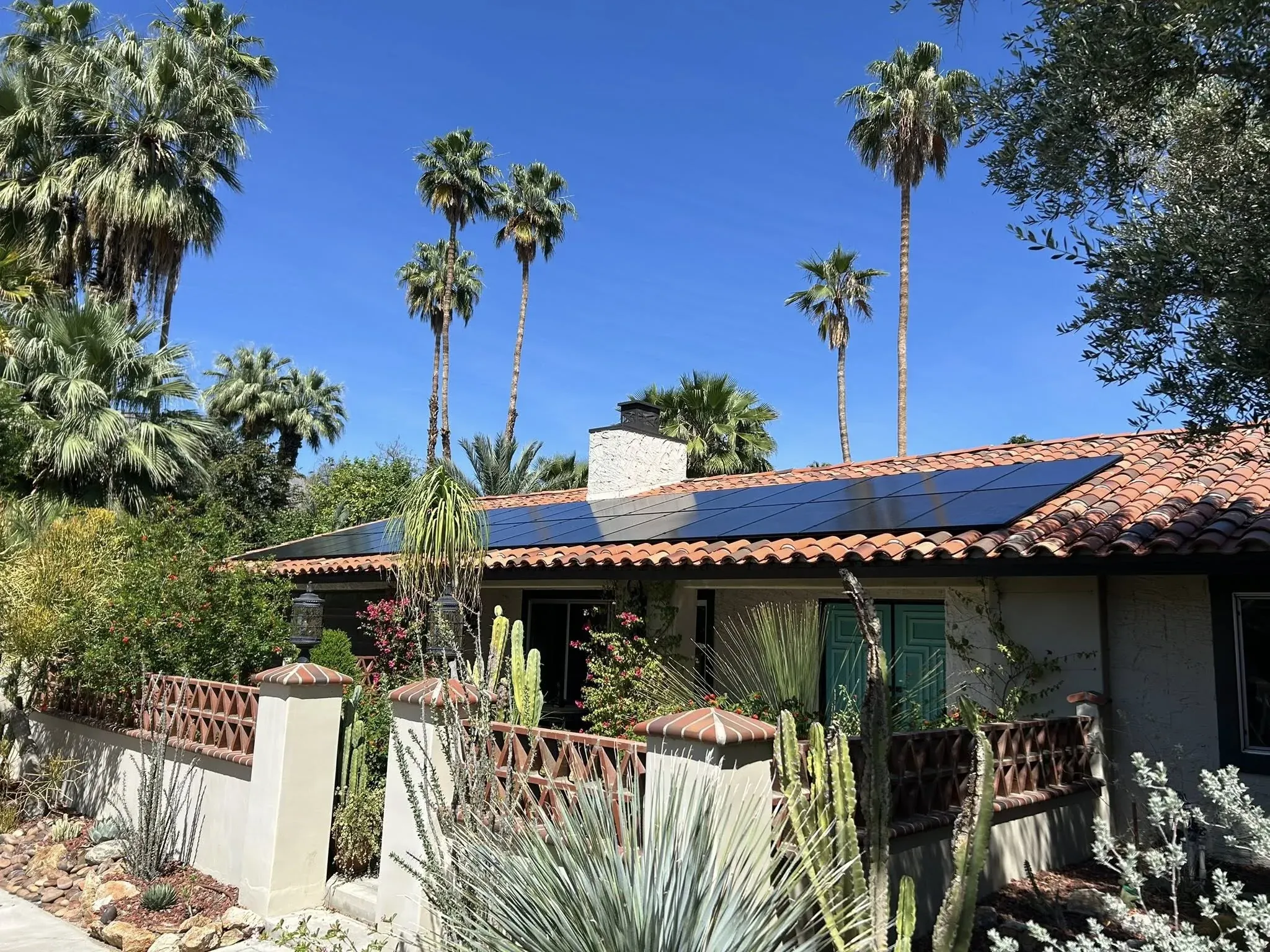Ground-level view of a Palm Springs home with the solar panels gleaming clean after a DronePower1 drone cleaning pass