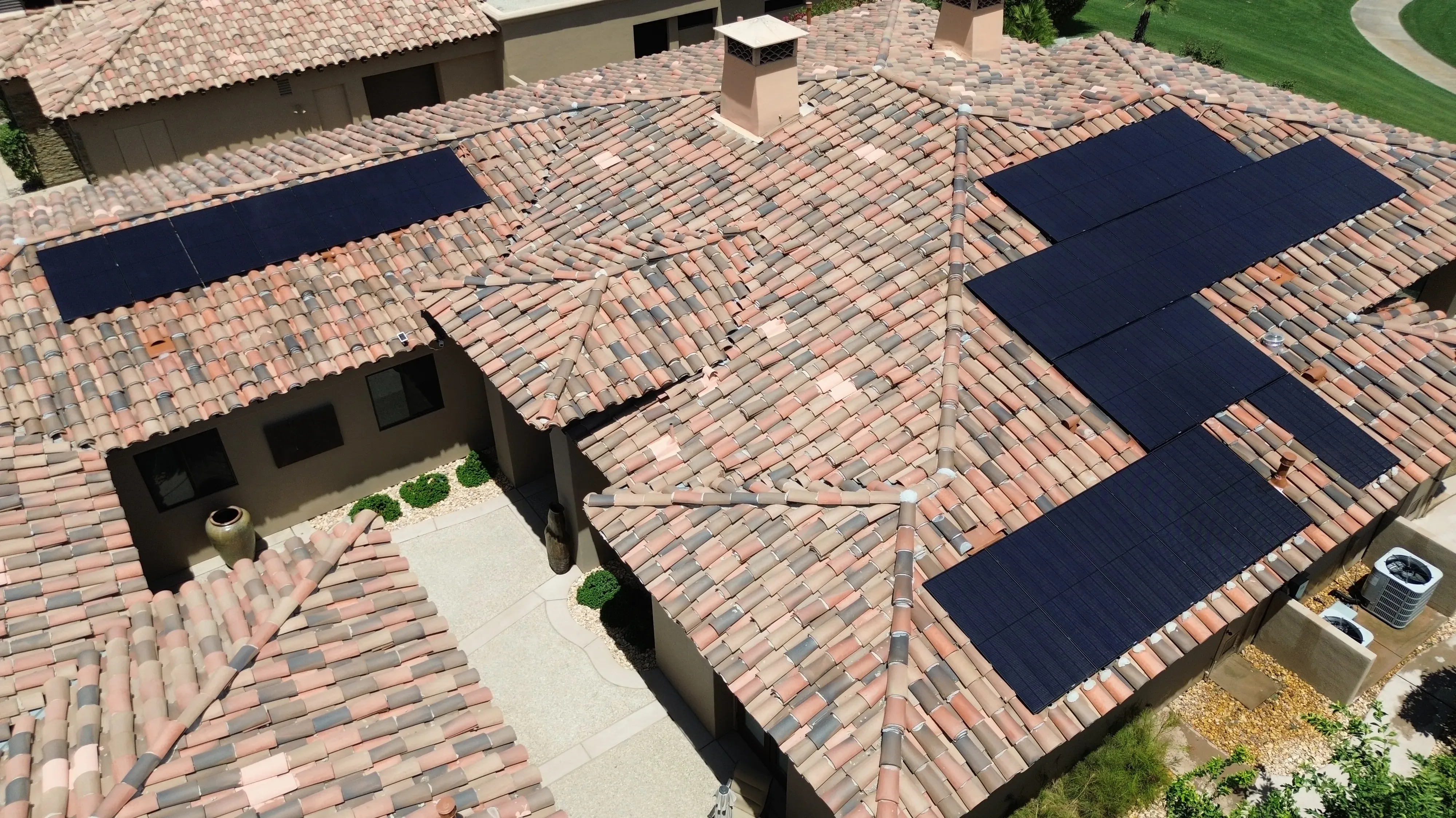 Overhead view of a commercial building rooftop with adjacent structures