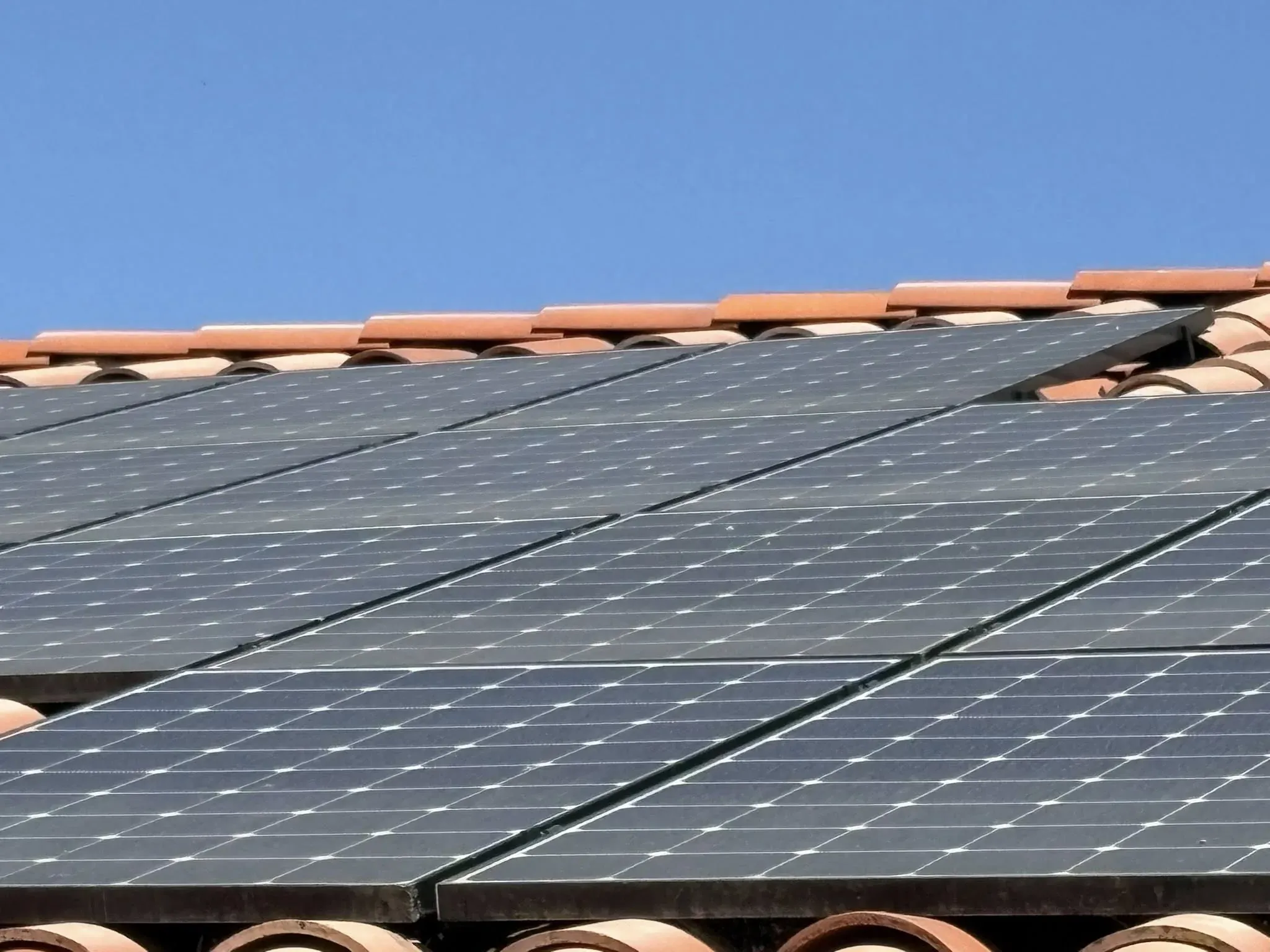 Detail view of rooftop solar panels and roof tile