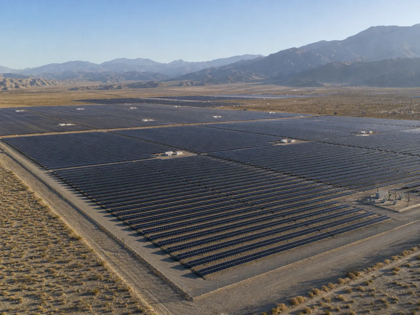 Aerial view of a utility-scale solar farm spanning the Coachella Valley desert